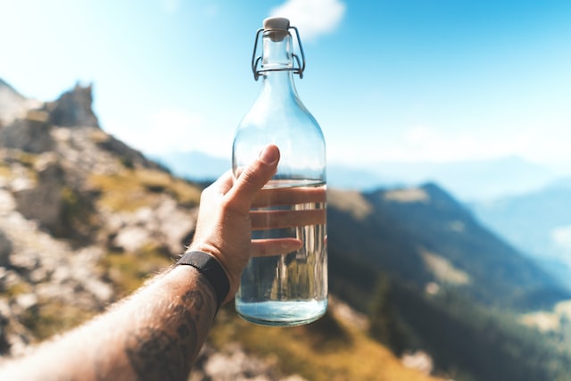 Bottle in the hand with the natural background