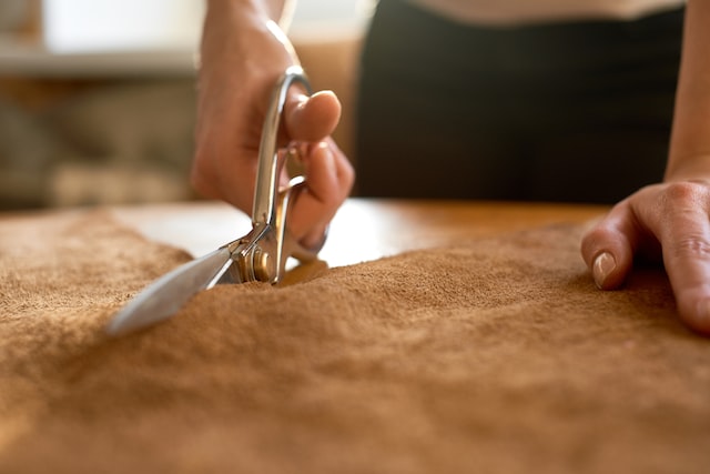 person cutting leather
