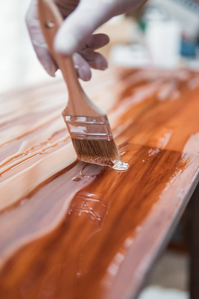 person holding brush with epoxy