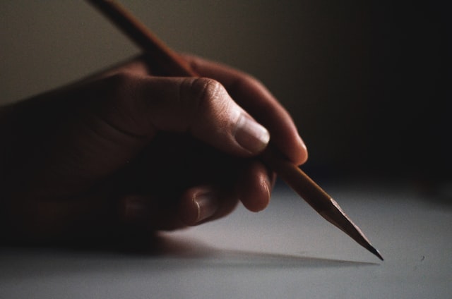 person holding pencil