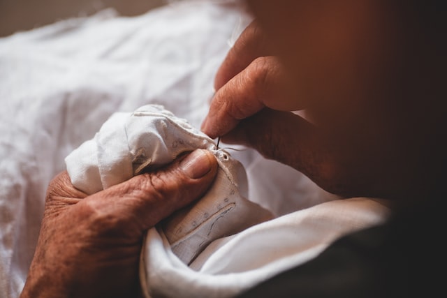 person sewing jeans