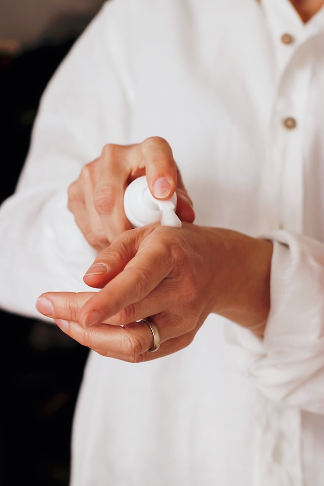 person using hand cream