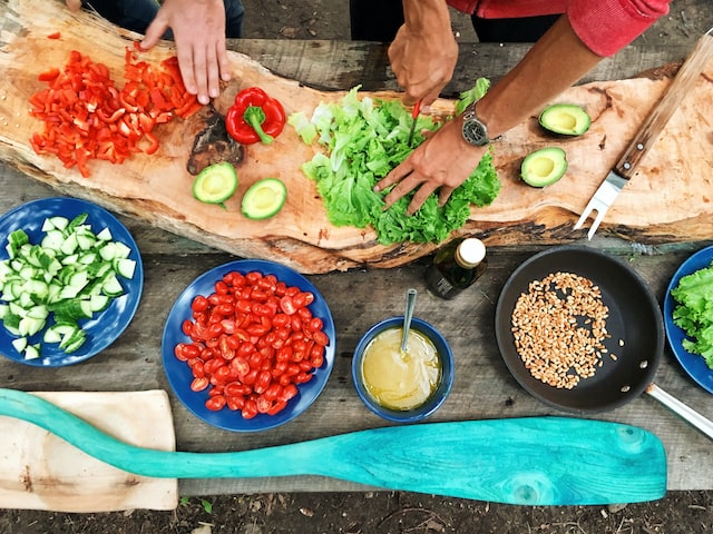 persons cooking outdoors