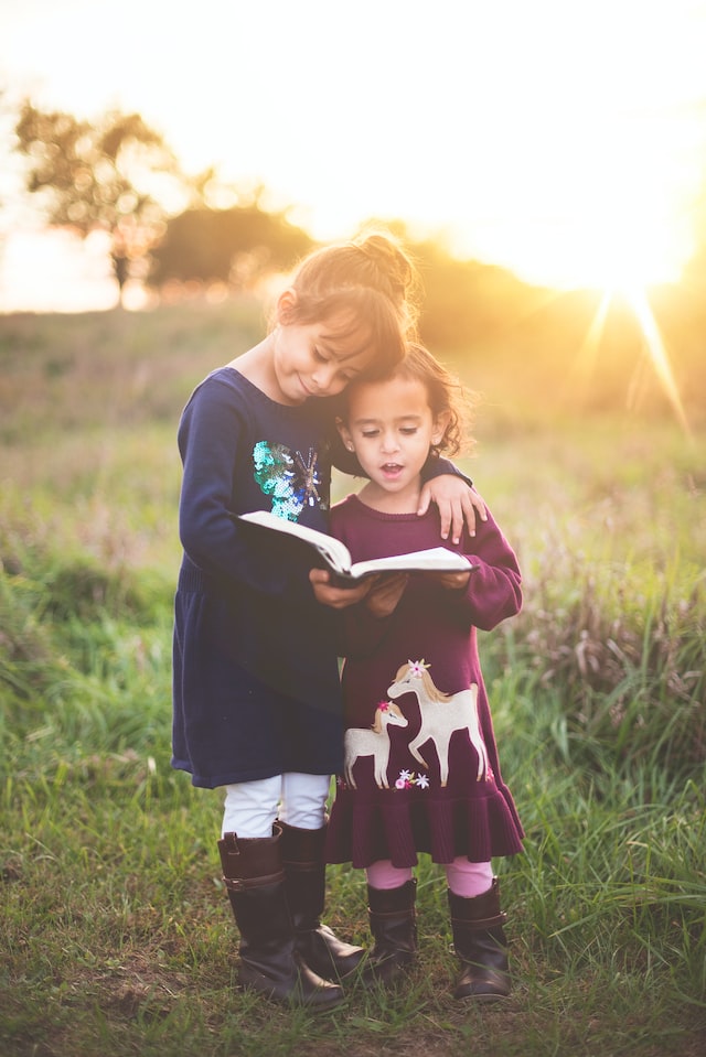 two girls are reading book