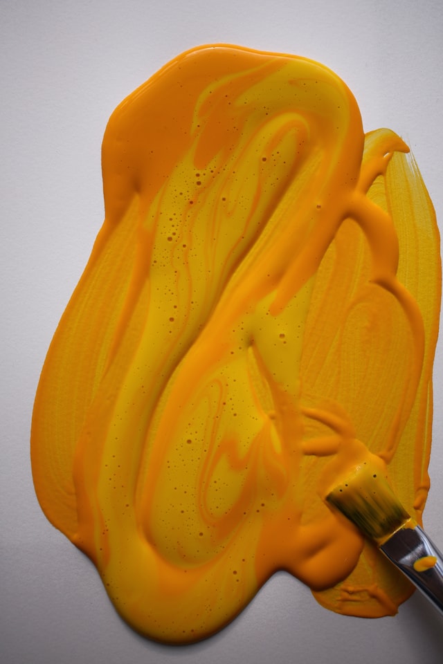 yellow acrylic paint with brush