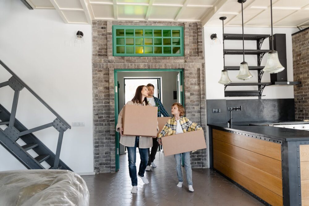 a-mother-and-child-carrying-cardboard-boxes-into-the-kitchen-area