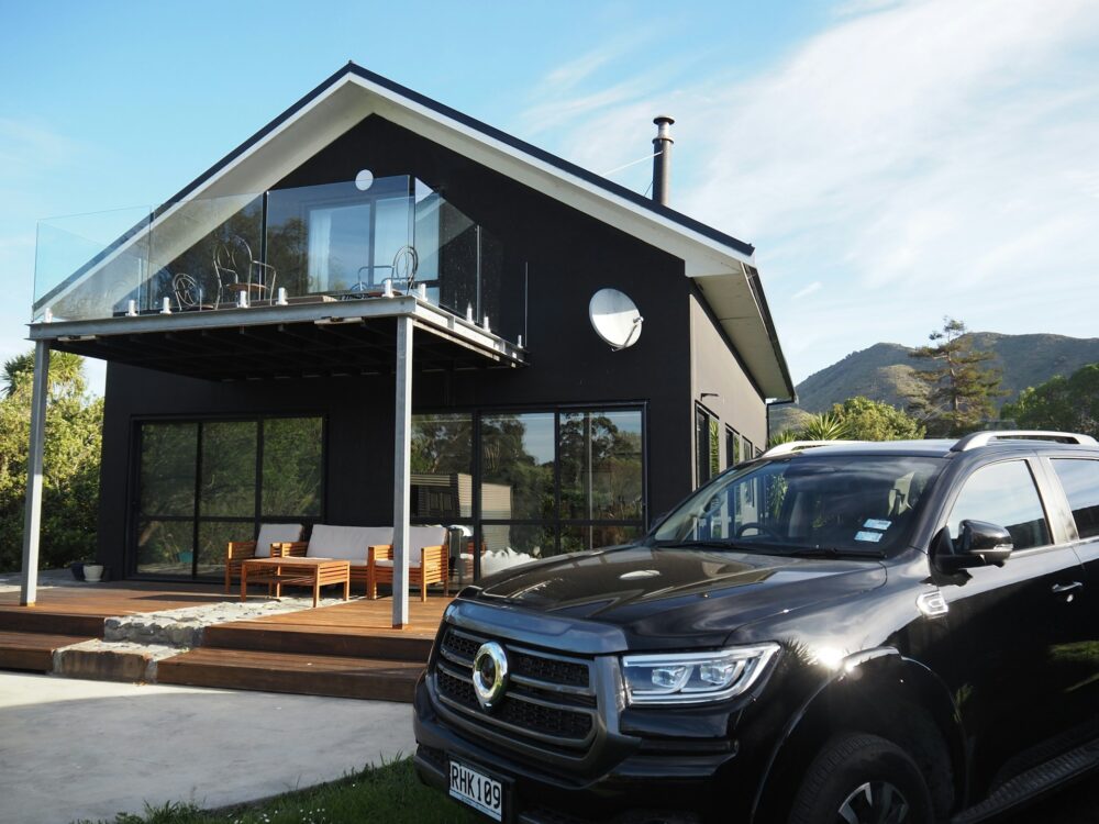 modern-black-house-with-a-car-parked-outside